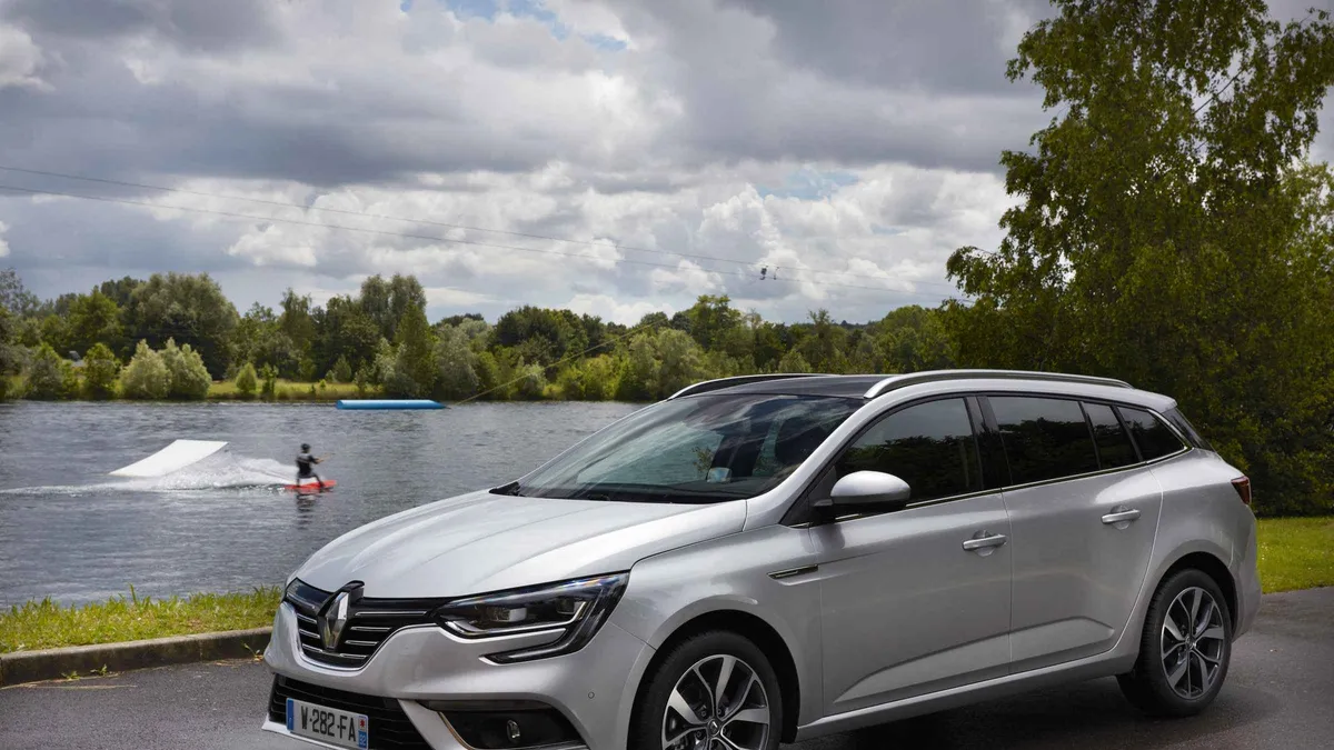 An estate car parked by a lake, the kind of vehicle used for a private airport transfer in Porto