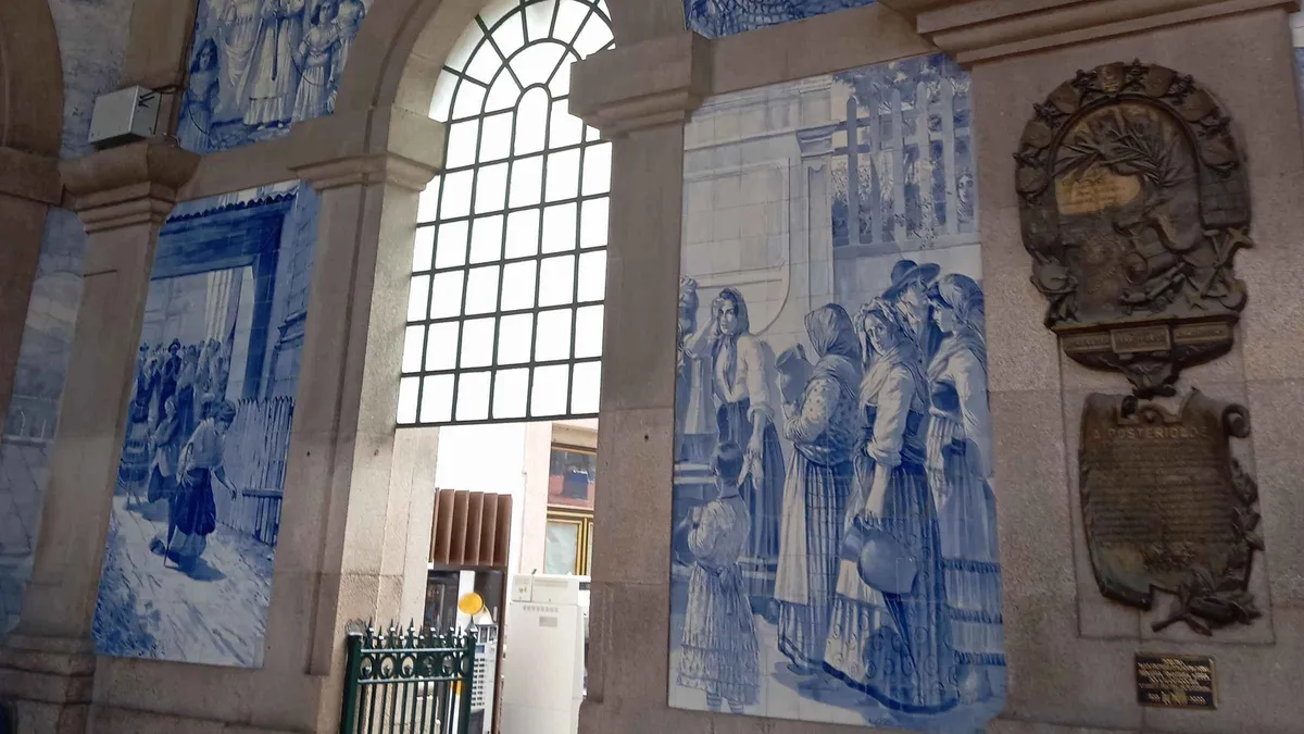 Blue-and-white azulejo panels lining a hall visited on a Porto walking tour